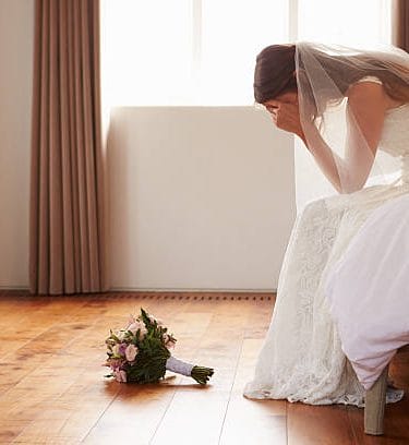 Bride In Bedroom Having Second Thoughts Before Wedding