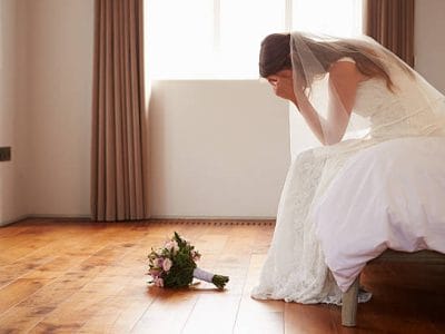 Bride In Bedroom Having Second Thoughts Before Wedding